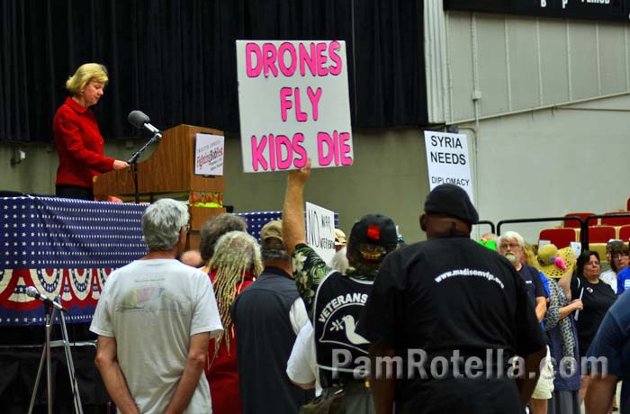 Anti-war activists protest Senator Tammy Baldwin at Fighting Bob Fest, 7 September 2013, photo by Pam Rotella