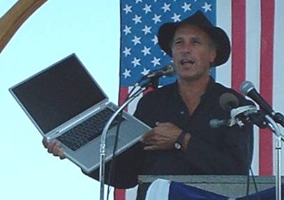 Greg Palast shows Katherine Harris' vote-rigging software to crowds at Fighting Bob Fest 2003